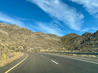 Curving desert highway winding through rocky Arizona mountains