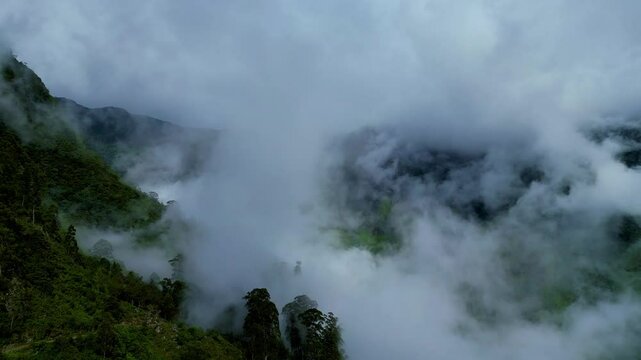 Drone soaring through mist and clouds, unveiling Sri Lanka's breathtaking highlands in 4K