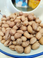 Natural and Rustic Display of Freshly Shelled Peanuts in a Decorative Bowl