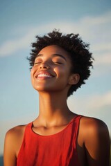 Happy young woman enjoying sunshine outdoors with a joyful expression, representing positivity and lifestyle in nature photography.
