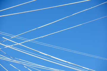 Fototapeta premium There are many aircraft tracks in the sky, forming long white lines.