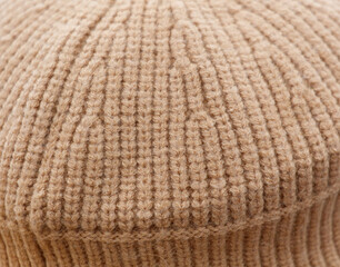 A close up of a knit hat with a tan color
