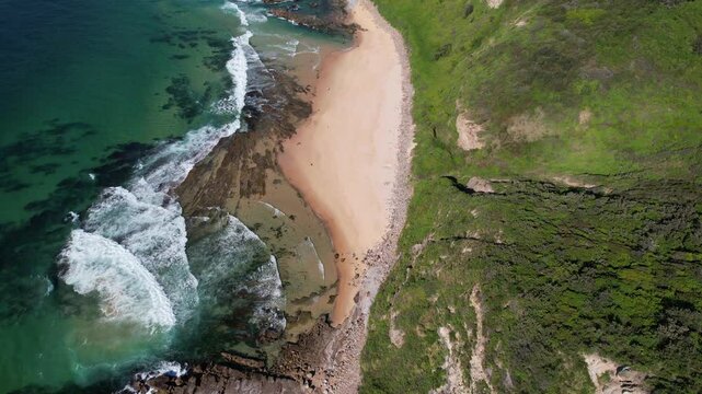 Bird's Eye View Of Ocean Waves And Beach, Glenrock Beach In New South Wales, Australia - Drone Shot