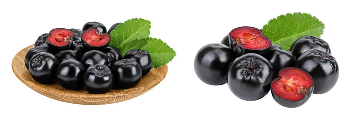 Chokeberry in wooden bowl isolated on white background. Black aronia.