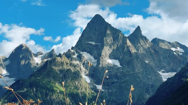Teberdinsky Nature Reserve. View of Kosygin's glade in the Gonachkhir gorge and the top of Dombai-Ulgen mountain near Lake Tumanly-Kel on a sunny summer day. Panoramic landscape. Resort. 4K