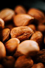 Delicious hazelnuts arranged on a plate against a contrasting black background for an elegant presentation