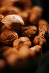 Hazelnuts arranged neatly on a plate against a contrasting black background highlighting their natural textures