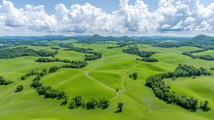 Fototapeta premium Aerial view rolling green hills, sunny day, pastoral landscape, travel brochure