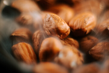 Hazelnuts arranged neatly on a plate set against a contrasting black background for a striking visual appeal