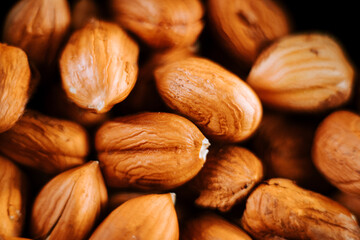 Hazelnuts arranged artfully on a plate showcasing their natural texture against a dark background