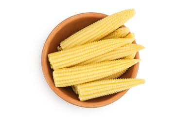 Pickled young baby corn cobs in wooden bowl isolated on white background. Top view. Flat lay
