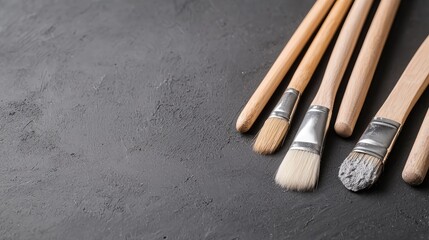 Obraz premium Paintbrushes on dark stone surface