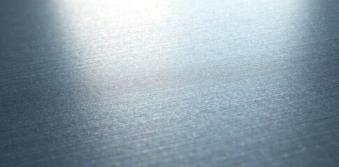 Close-up of brushed silver, showing fine lines and metallic sheen, worn, surface, shiny surface