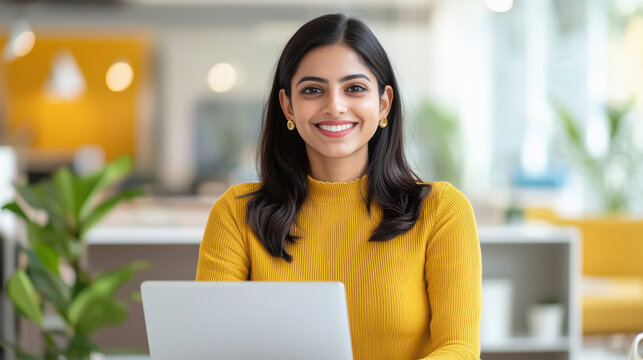 young indian business woman working on laptop - Powered by Adobe