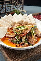 Stir-fried pork with black bean and garlic sprouts served with rolls