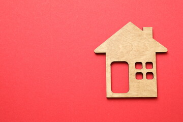 Wooden house on color background