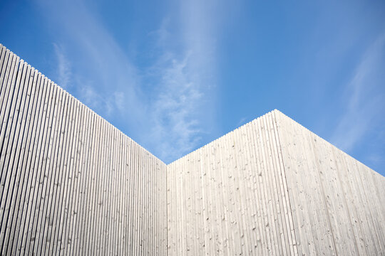 Modern wooden building facade with blue sky background