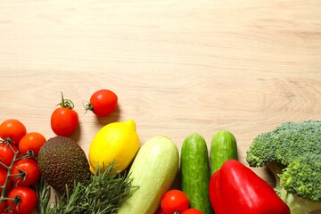 Clean healthy eating habits concept. Fruits, herbs, greens and vegetables mix, colorful juicy organic detox smoothie juice ingredients, wooden background. Vegan vegetarian diet food