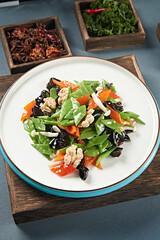 Stir-fried snow peas, bell peppers, black fungus, seafood, mushrooms and peach kernels