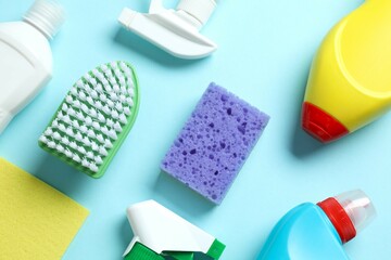 Many different cleaning products on color background, top view