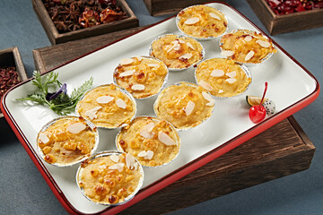 Baked sweet potato mash with almond slices and cheese