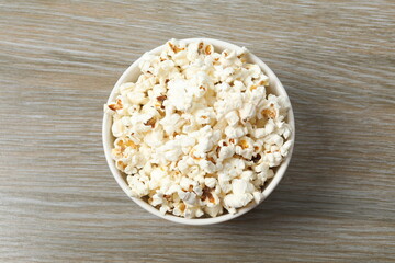 Popcorn in a bowl on wooden background