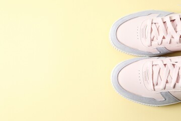 Pair of stylish sneakers on a colored background, space for text