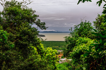 Panoramic nature background of the landscape with views of mountains, sea, trees and fishermen's houses. The beauty of the forest during the seasonal tourism season.