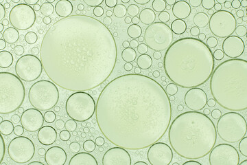 Macro microscope green bubble texture, Close-up Green bubbles and drops oil background . blue green water bubbles, close up golden oil drop for cosmetic...