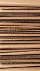 Neatly arranged stack of recycled cardboard sheets showcasing texture and layers. Ideal for eco friendly projects and packaging solutions