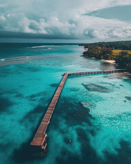 Stunning Aerial View of a Wooden Pier Extending into a Turquoise Ocean with Lush Tropical Coastline