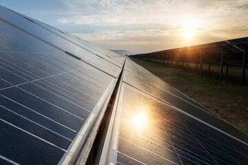 Sunset at Solar power station. Solar panels, photovoltaics, alternative source of electricity -...