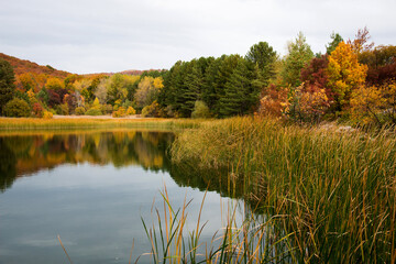 Peaceful and colorful autumn landscape with beautiful reflections in the lake.