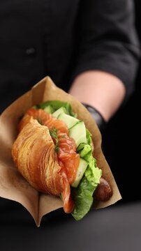 Croissant with salmon, cheese and greens.