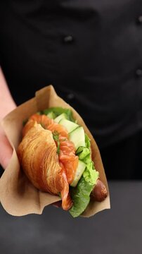Croissant with salmon, cheese and greens.