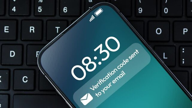 Verification code sent to your email notification appearing on the smartphone screen with laptop , 4k footage. 2FA, protected, secure, login, email notification