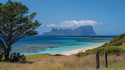 Tropical island beach view with distant mountain backdrop