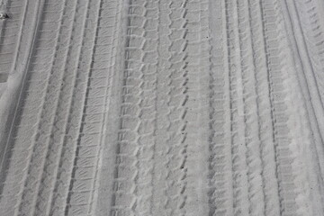 car tire prints on dusty road