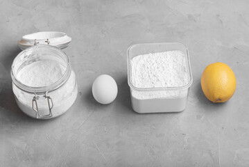Ingredients for making icing (sugar glaze for cookies and gingerbread): powdered sugar, egg, lemon