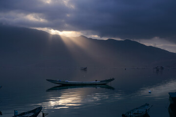 Landscape of lake at sunset with cloudy sky
