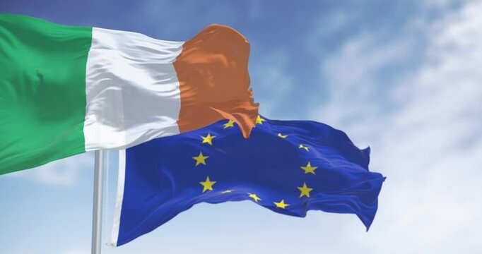 Ireland and the European Union flags waving on a clear day