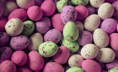 small chocolate eggs colored with the colors of the rainbow