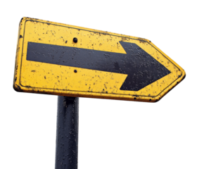 weathered one way street sign with black arrow pointing right, indicating direction. sign yellow background is faded and scratched, adding to its rustic charm