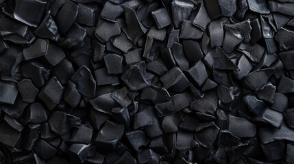 Surface of small black granules ideal for various industrial applications and processes in manufacturing settings