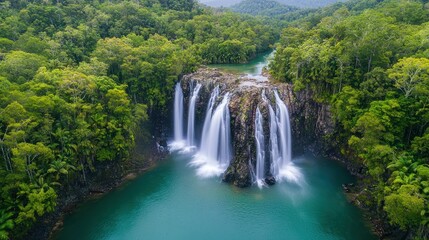 Fototapeta premium Tropical Waterfall Cascading into Emerald Pool, Lush Rainforest Background