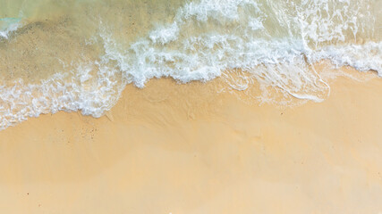 Beach sand background for summer vacation concept. Beach nature and summer seawater with sunlight light sandy beach Sparkling sea water	
