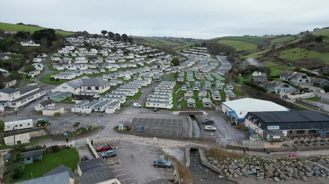 Aerial drone shot of identical static caravans arranged in rows, creating an urban holiday sprawl in Salcombe, showcasing a peaceful and spacious holiday environment.