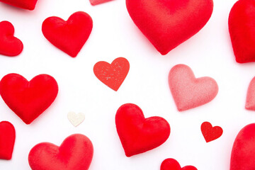 White bg multiple red plush hearts of different sizes with glitter details