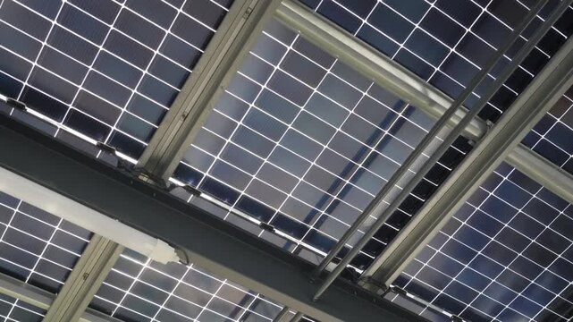 revealing shot of a large solar panel collection ontop of a buildings roof
