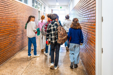 Students walking in school hallway between classes